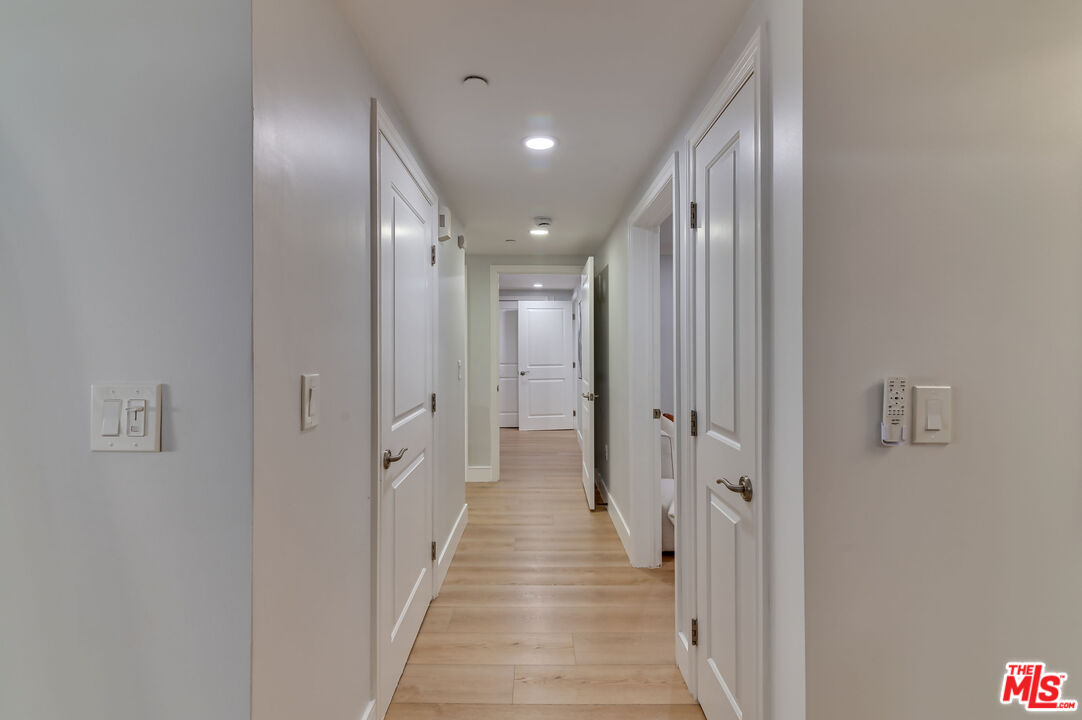 1878 Greenfield Avenue, Unit 104 Los Angeles, CA 90025 - Photo 12 of 35 a view of a hallway with a wooden floor