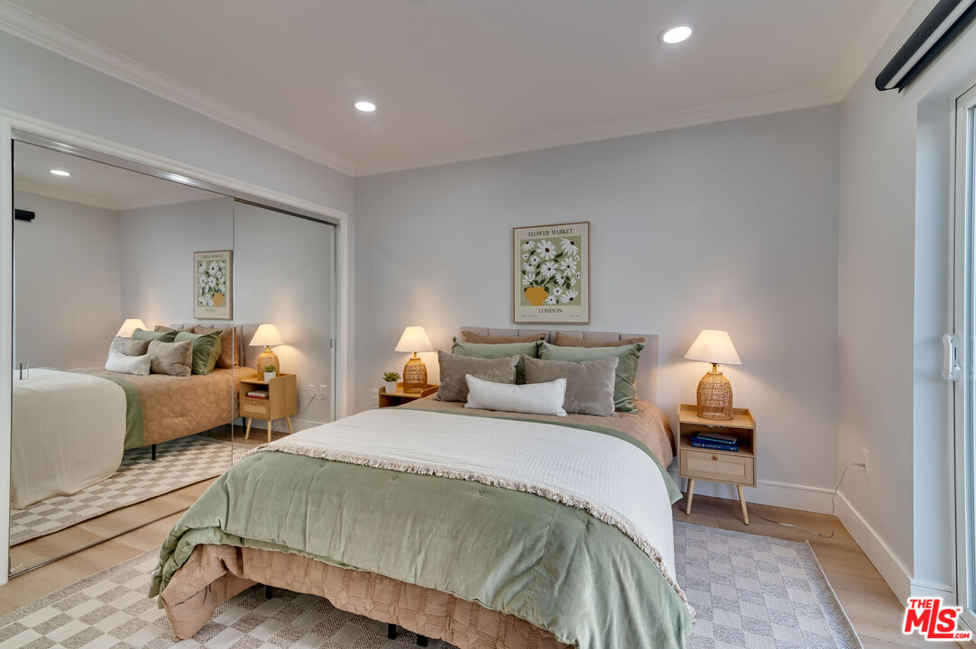 1878 Greenfield Avenue, Unit 104 Los Angeles, CA 90025 - Photo 16 of 35 a spacious bedroom with a bed and a couch
