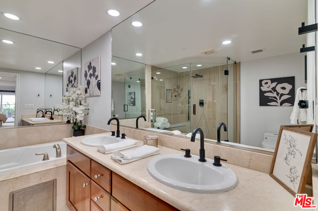1878 Greenfield Avenue, Unit 104 Los Angeles, CA 90025 - Photo 17 of 35 a bathroom with a sink double vanity and a mirror