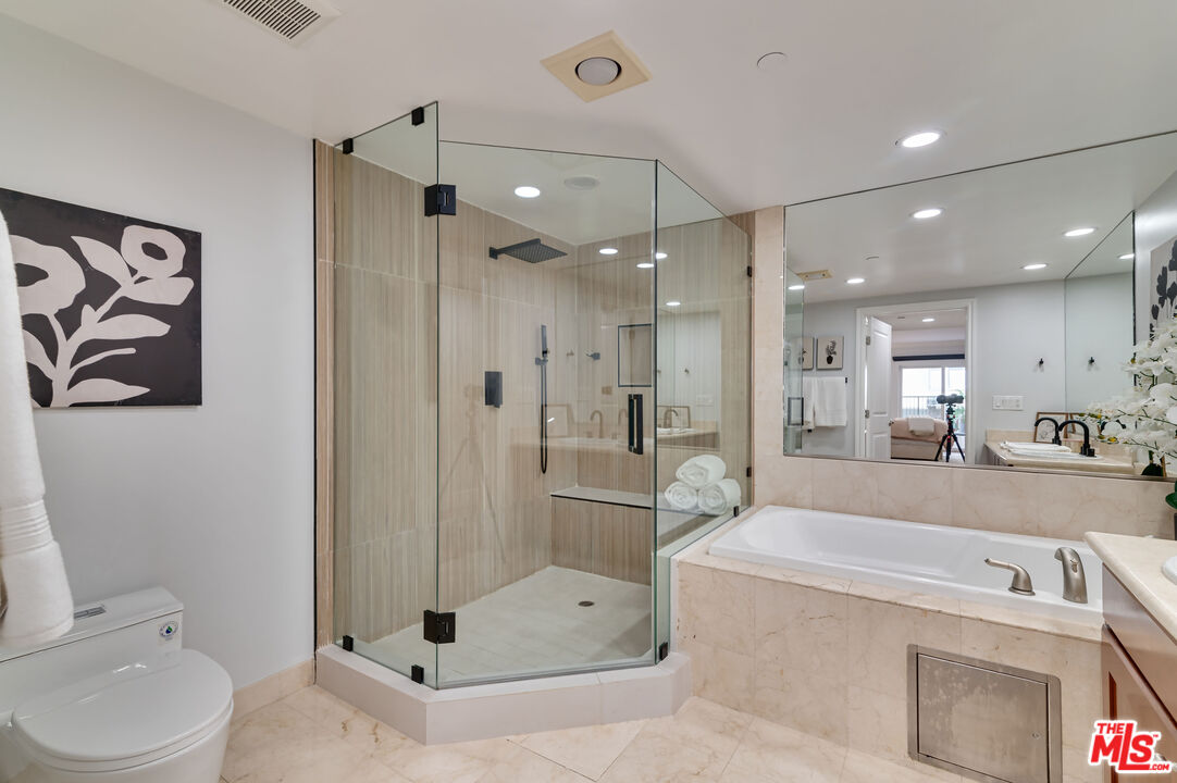 1878 Greenfield Avenue, Unit 104 Los Angeles, CA 90025 - Photo 18 of 35 a bathroom with a tub a toilet and a shower