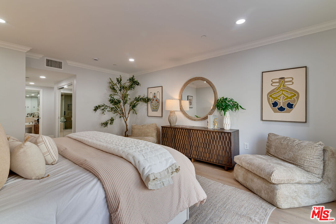 1878 Greenfield Avenue, Unit 104 Los Angeles, CA 90025 - Photo 20 of 35 a bed room with bed and a painting on the wall