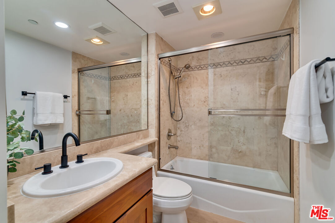 1878 Greenfield Avenue, Unit 104 Los Angeles, CA 90025 - Photo 23 of 35 a bathroom with a sink toilet and shower