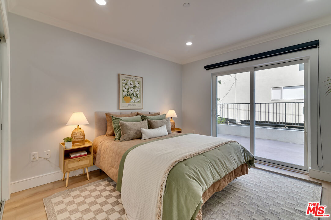1878 Greenfield Avenue, Unit 104 Los Angeles, CA 90025 - Photo 24 of 35 a bedroom with a bed and a window