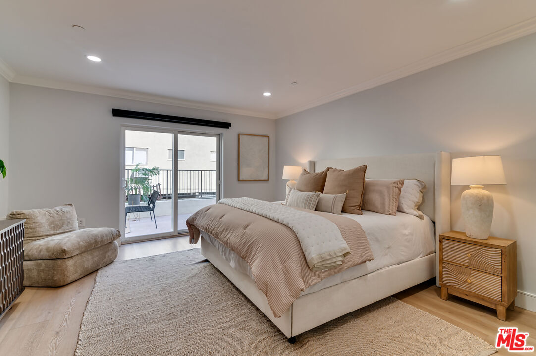 1878 Greenfield Avenue, Unit 104 Los Angeles, CA 90025 - Photo 27 of 35 a spacious bedroom with a bed and a couch