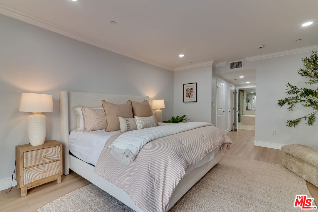 1878 Greenfield Avenue, Unit 104 Los Angeles, CA 90025 - Photo 29 of 35 a spacious bedroom with a bed and a couch