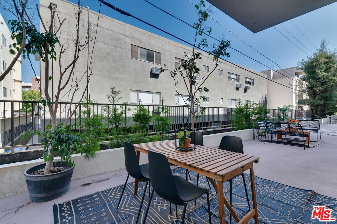 1878 Greenfield Avenue, Unit 104 Los Angeles, CA 90025 - Photo 30 of 35 a outdoor dining space with furniture and a potted plant
