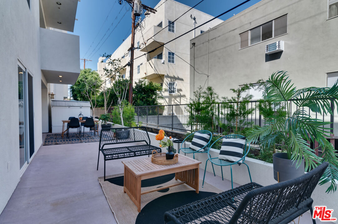 1878 Greenfield Avenue, Unit 104 Los Angeles, CA 90025 - Photo 31 of 35 a view of a patio with couches and potted plants