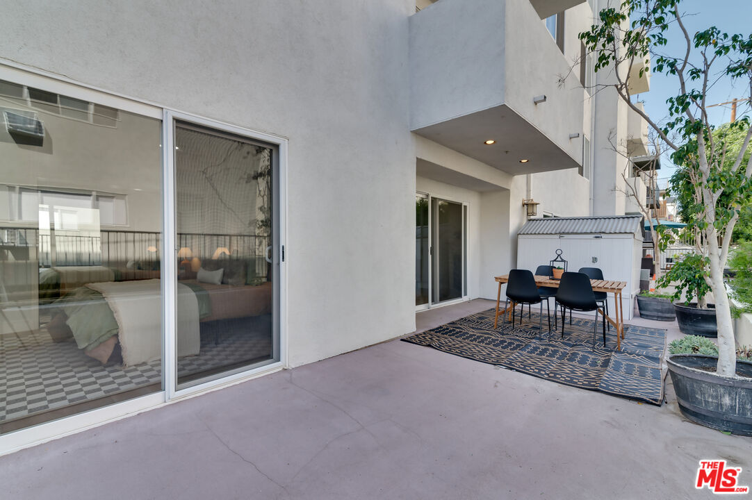 1878 Greenfield Avenue, Unit 104 Los Angeles, CA 90025 - Photo 32 of 35 a dining room with furniture and a potted plant