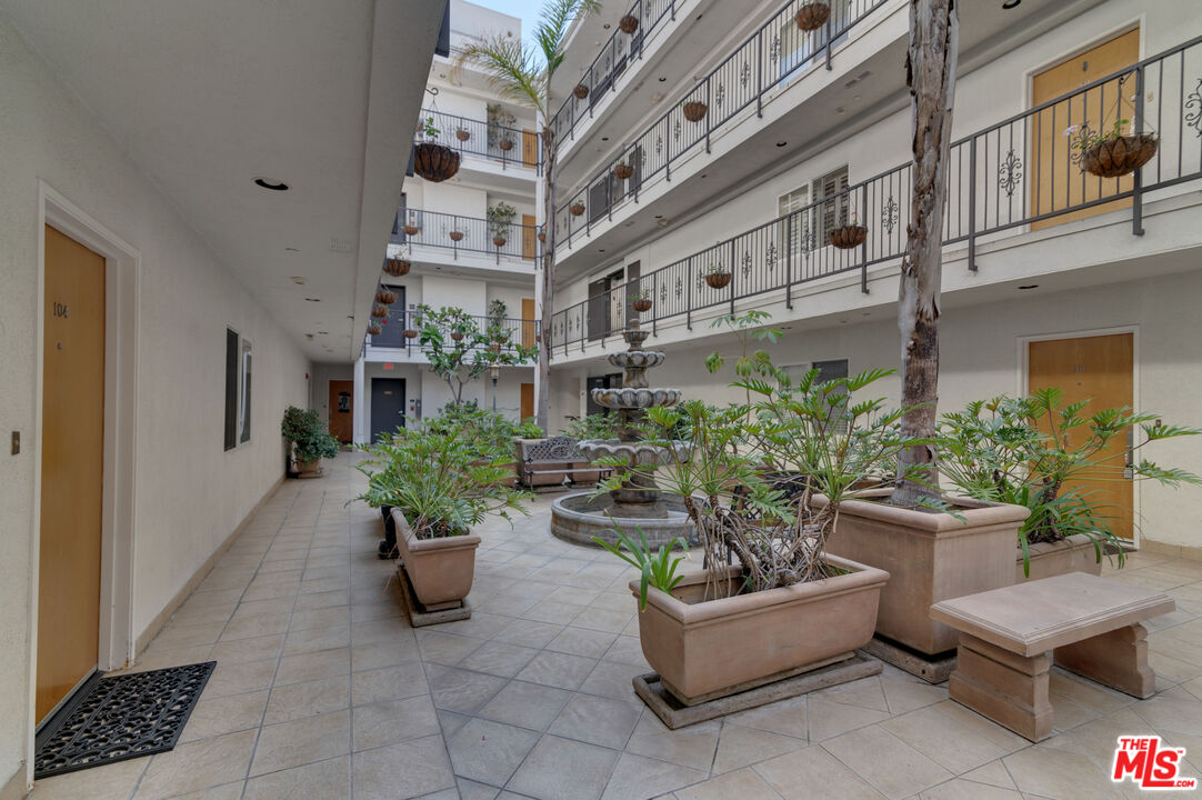 1878 Greenfield Avenue, Unit 104 Los Angeles, CA 90025 - Photo 34 of 35 a view of a patio with plants and chairs