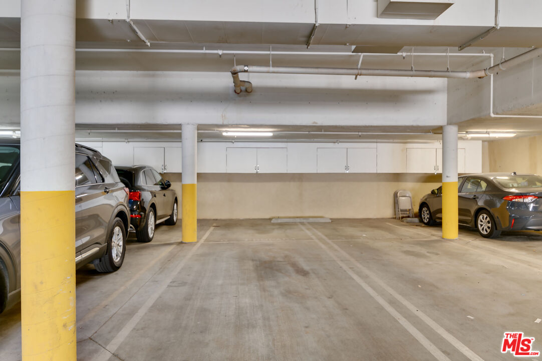 1878 Greenfield Avenue, Unit 104 Los Angeles, CA 90025 - Photo 35 of 35 a view of parking garage with cars