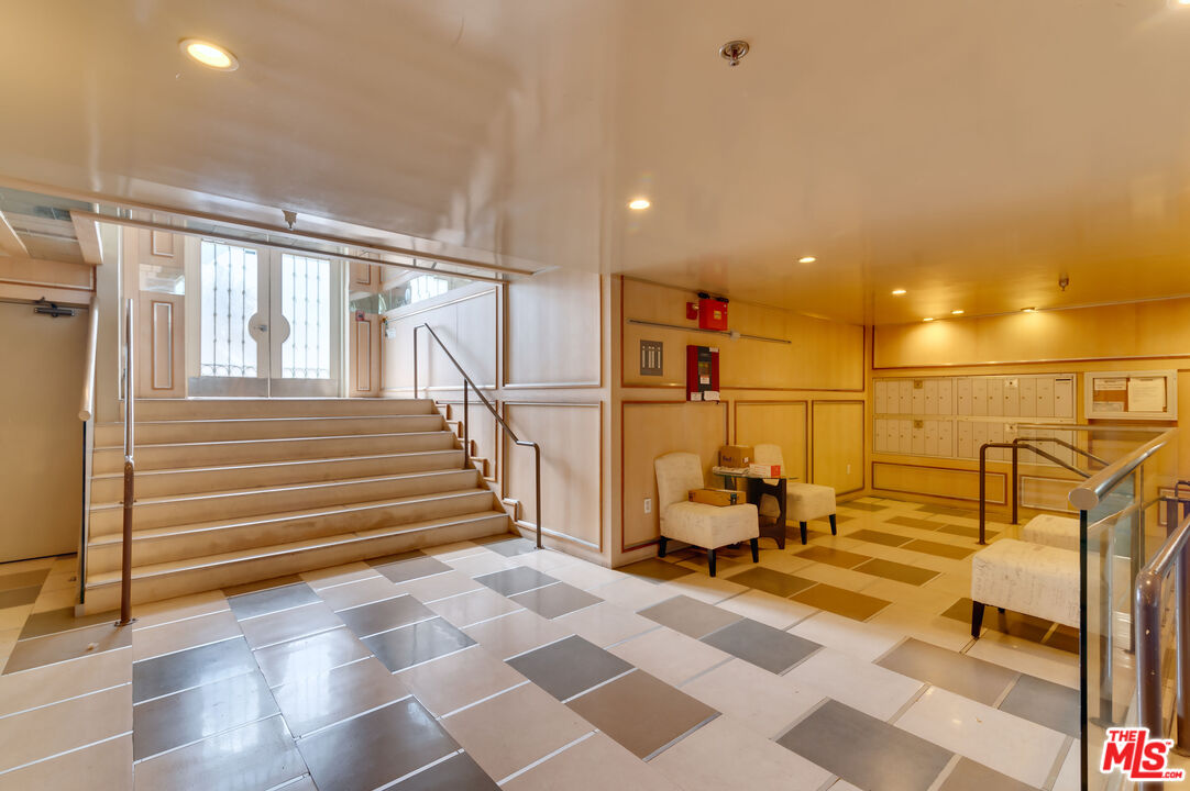 1878 Greenfield Avenue, Unit 104 Los Angeles, CA 90025 - Photo 4 of 35 a view of a hall with wooden floor and a sink