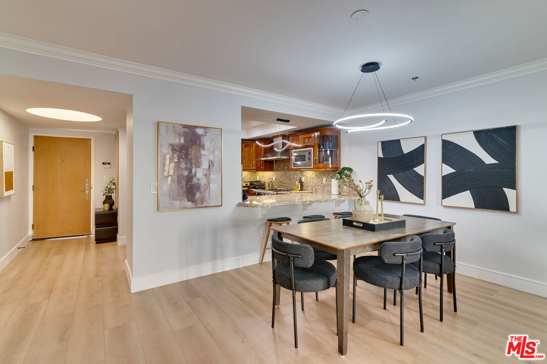 1878 Greenfield Avenue, Unit 104 Los Angeles, CA 90025 - Photo 6 of 35 a view of a dining room with furniture and wooden floor
