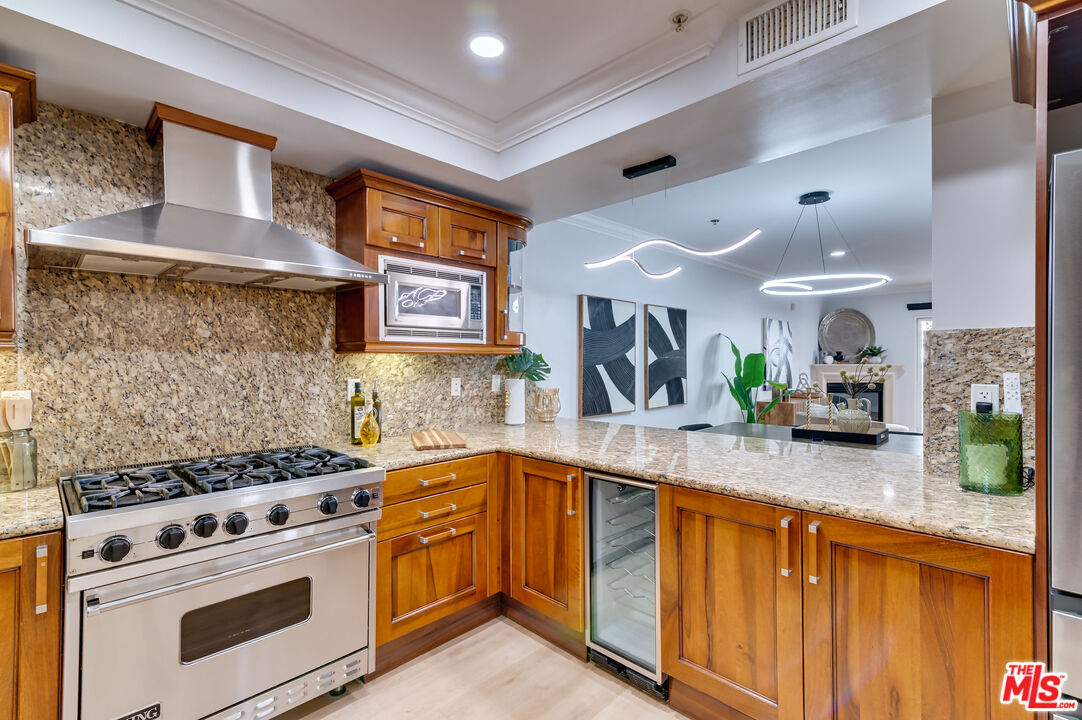 1878 Greenfield Avenue, Unit 104 Los Angeles, CA 90025 - Photo 10 of 35 a kitchen with stainless steel appliances granite countertop a stove and a sink