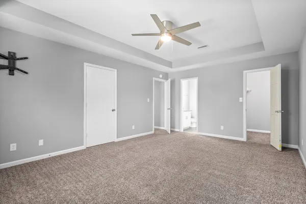a view of an empty room with a ceiling fan
