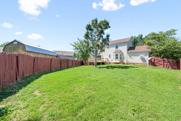 a view of a house with backyard and sitting area