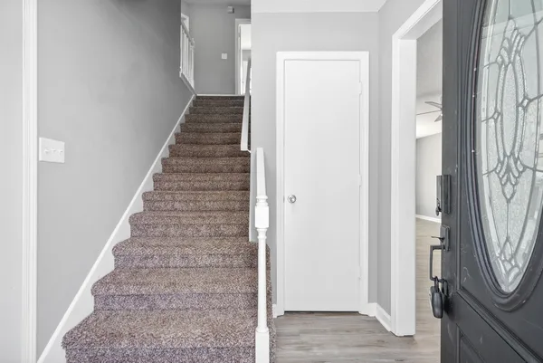 a view of a hallway with wooden floor and entryway