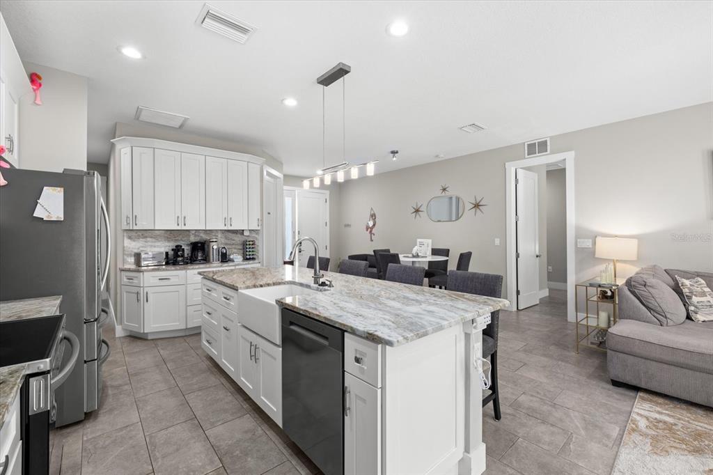 279 Avalon Road Venice, FL 34293 - Photo 14 of 32 a kitchen with a stove a sink and a refrigerator