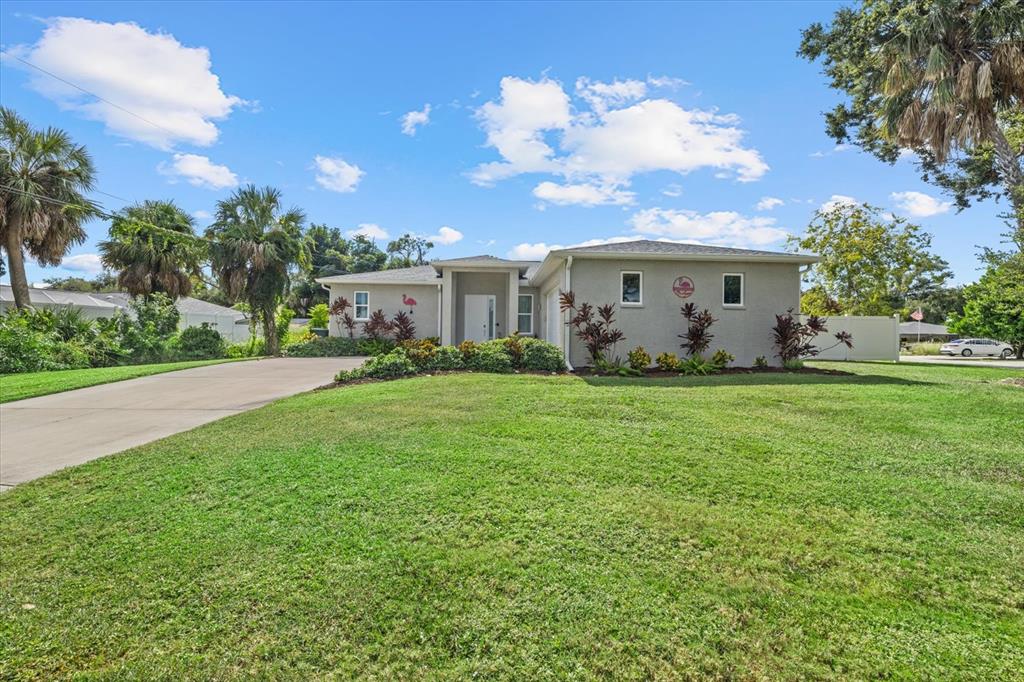 279 Avalon Road Venice, FL 34293 - Photo 2 of 32 a view of a house with yard and a garden