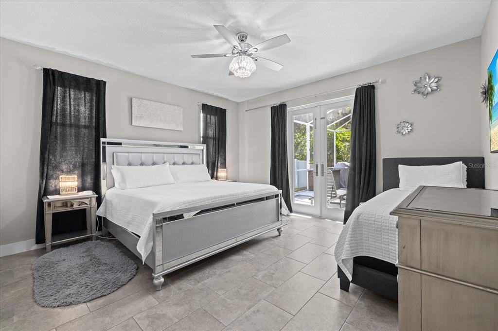279 Avalon Road Venice, FL 34293 - Photo 22 of 32 a bedroom with a bed and a chandelier