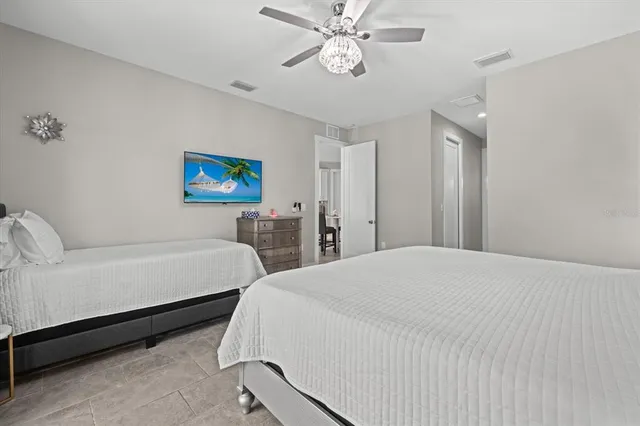 a bedroom with a bed and a chandelier