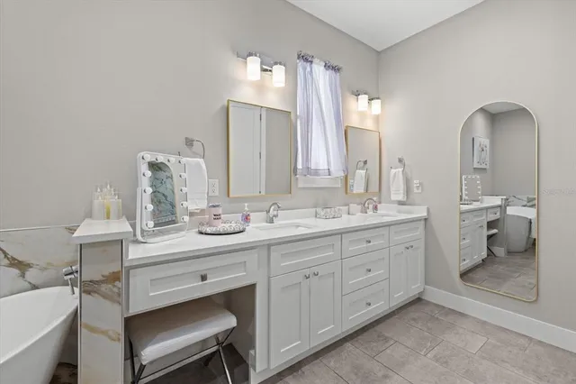 a bathroom with a double vanity sink and a toilet