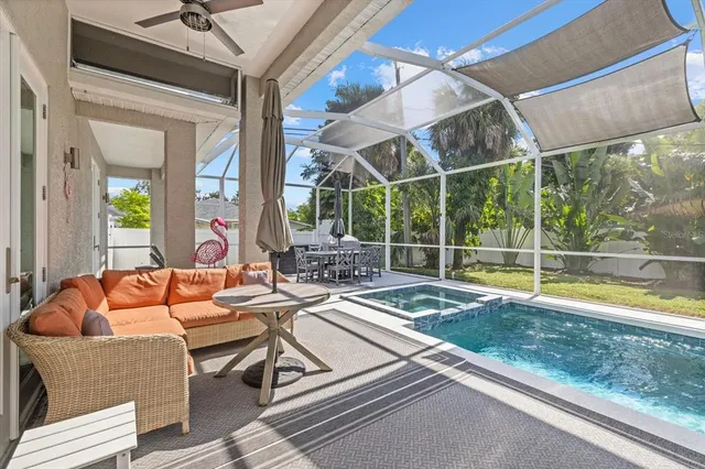 a outdoor space with the couches and dining table with the backyard view