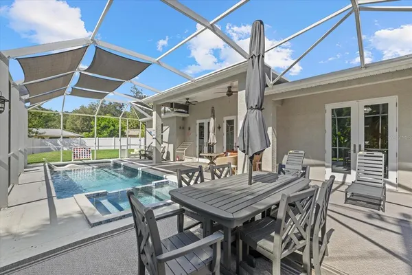 a view of outdoor dining space with a table and chairs