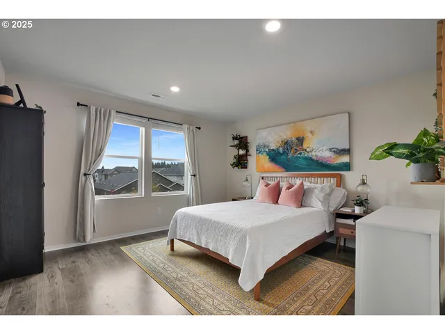 a bedroom with a large bed and a large window