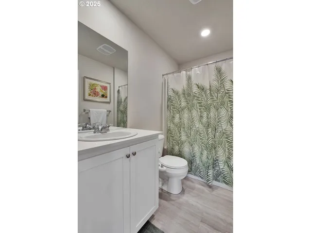 a bathroom with a sink toilet a mirror and shower