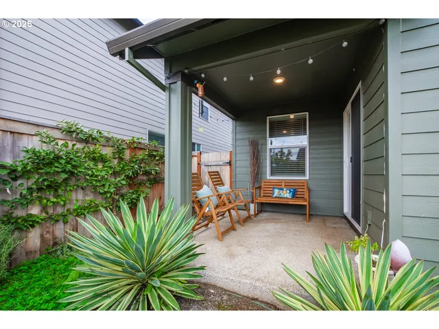 a view of a porch with a table and chairs