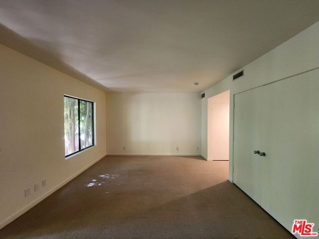 a view of an empty room with windows
