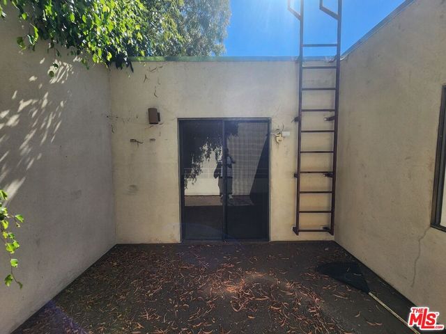 a view of wooden door and utility room
