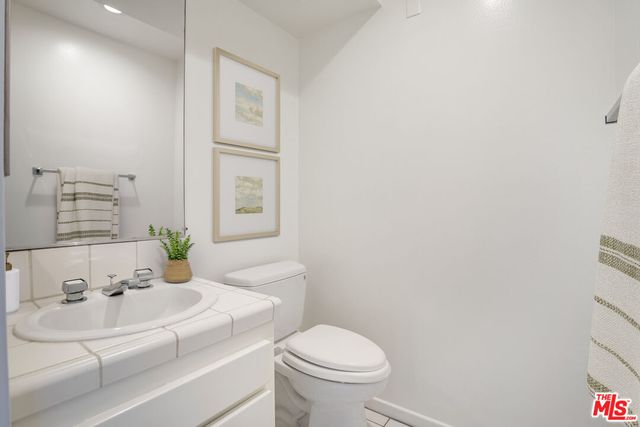 a bathroom with a sink toilet and mirror
