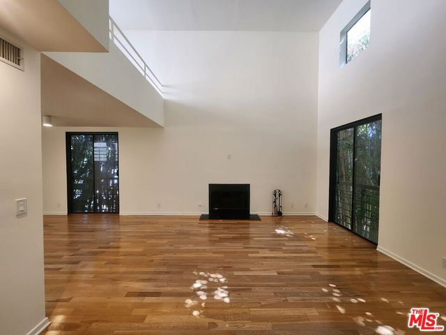 a view of an empty room with closet and a window