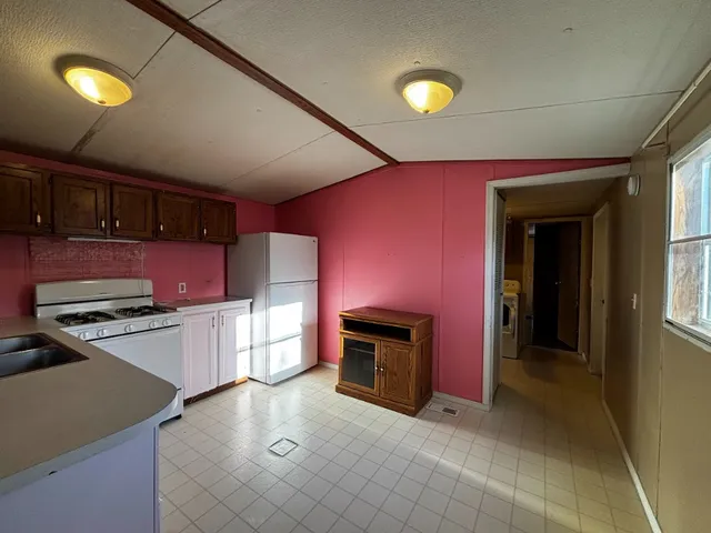a kitchen with stainless steel appliances granite countertop a stove cabinets and a refrigerator