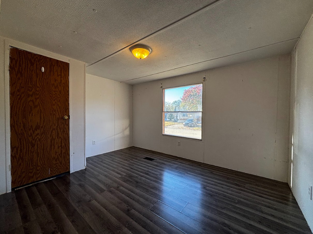 29 Pulaski Street Mahomet, IL 61853 - Photo 10 of 17 an empty room with wooden floor and windows