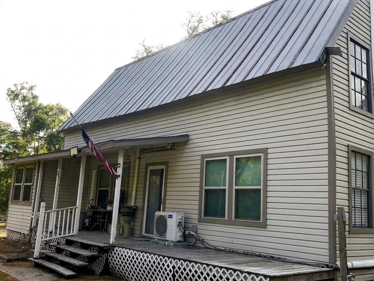 24300 County Road 332 Sweeny, TX 77480 - Photo 1 of 27 a view of a house with a large window and wooden fence
