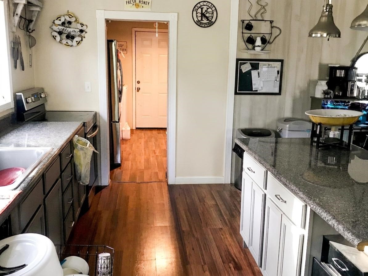 24300 County Road 332 Sweeny, TX 77480 - Photo 11 of 27 a kitchen with granite countertop a sink stove and cabinets