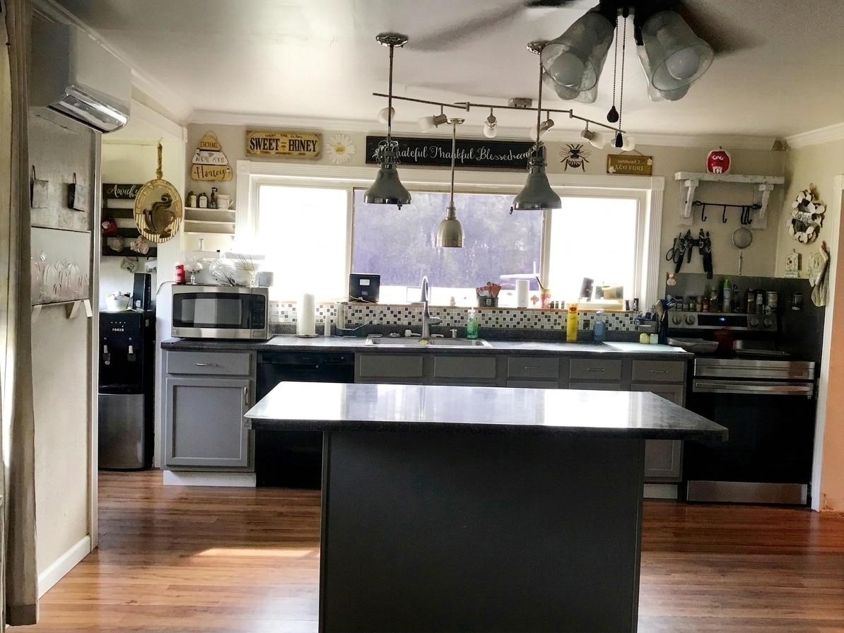 24300 County Road 332 Sweeny, TX 77480 - Photo 9 of 27 a kitchen with stainless steel appliances granite countertop a stove a refrigerator and a sink