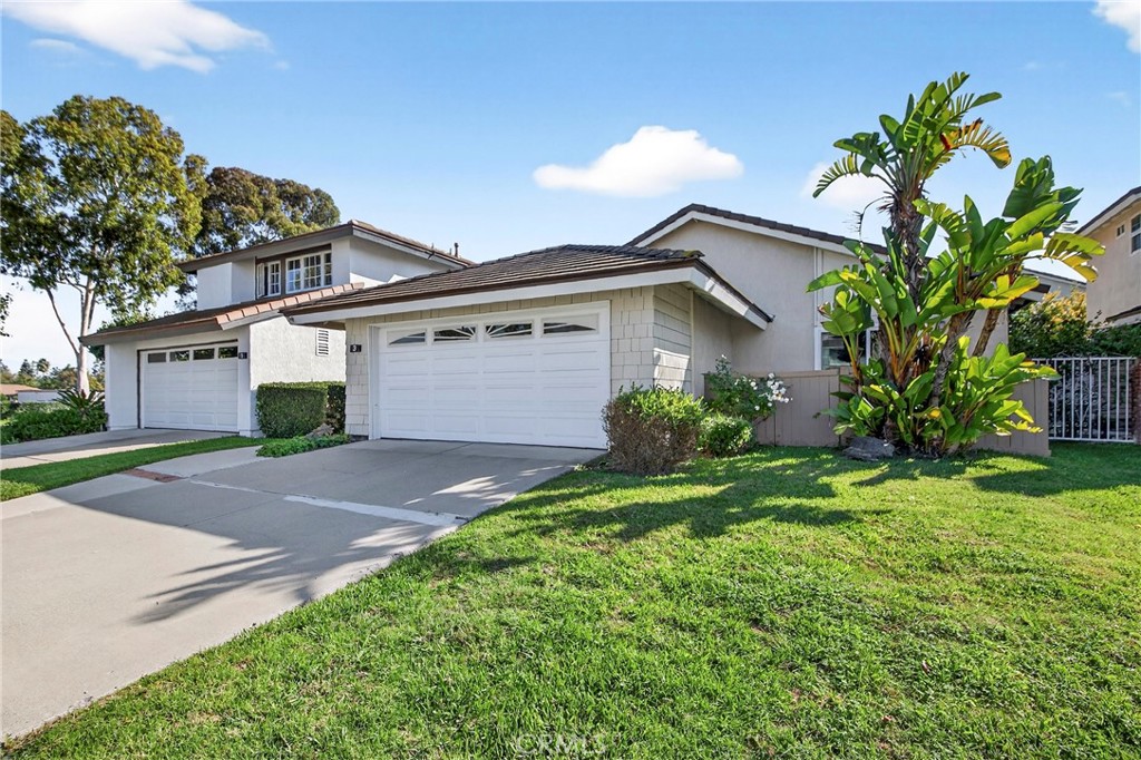 a front view of a house with a yard and a garage