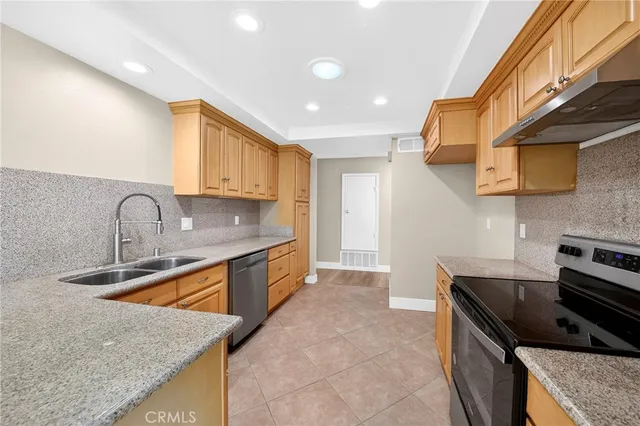 a kitchen that has a sink and a stove
