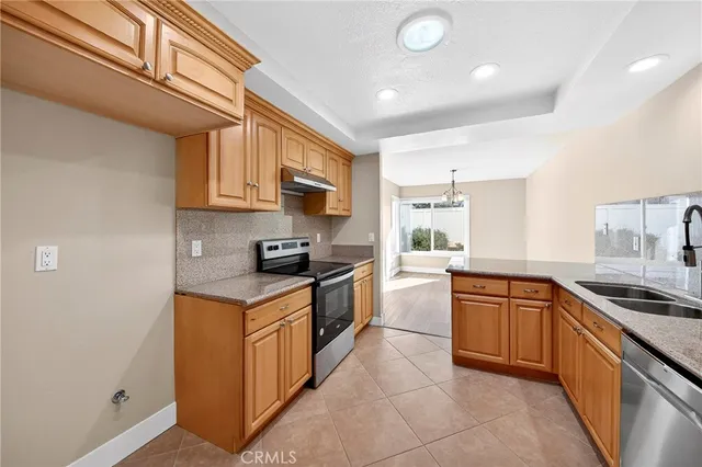 a kitchen with stainless steel appliances granite countertop a sink and cabinets