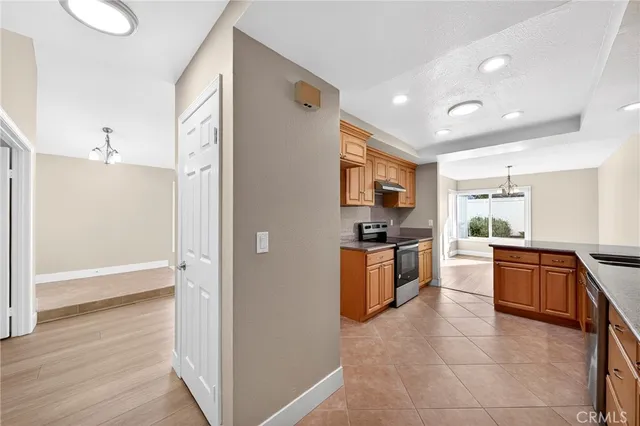 a large kitchen with cabinets and stainless steel appliances