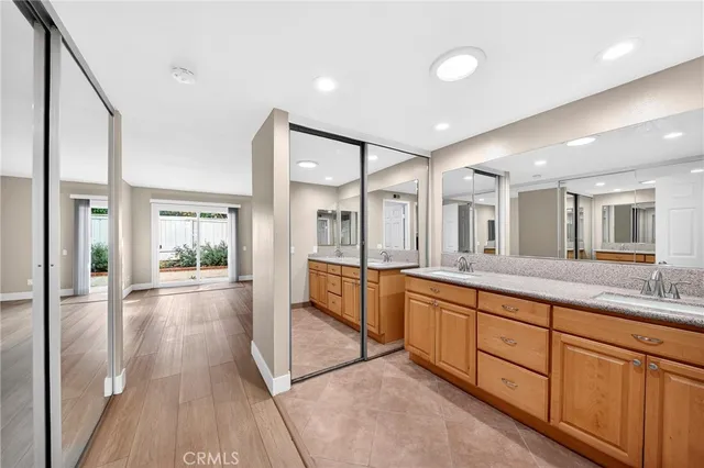 a large bathroom with a large mirror vanity and shower