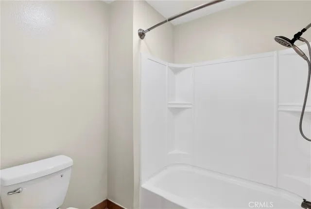 a bathroom with a shower and a toilet
