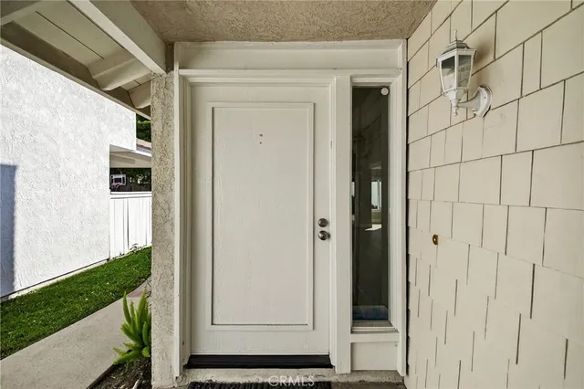 a view of a porch with couches and potted plants