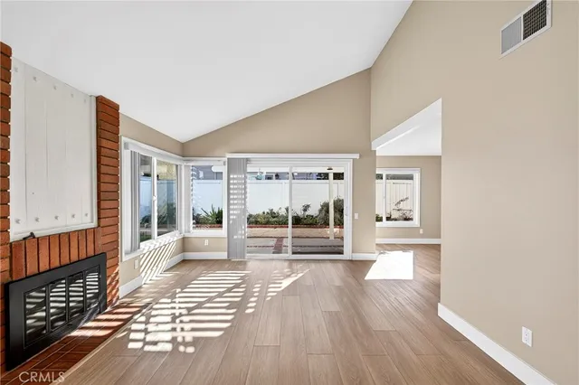 a view of a room with wooden floor and windows