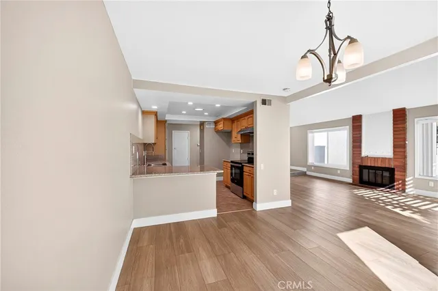 a view of a living room and kitchen with furniture wooden floor and window
