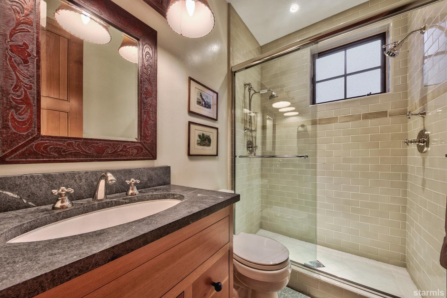 373 Fallen Leaf Road Fallen Leaf, CA 96150 - Photo 11 of 40 a bathroom with a granite countertop sink toilet and shower