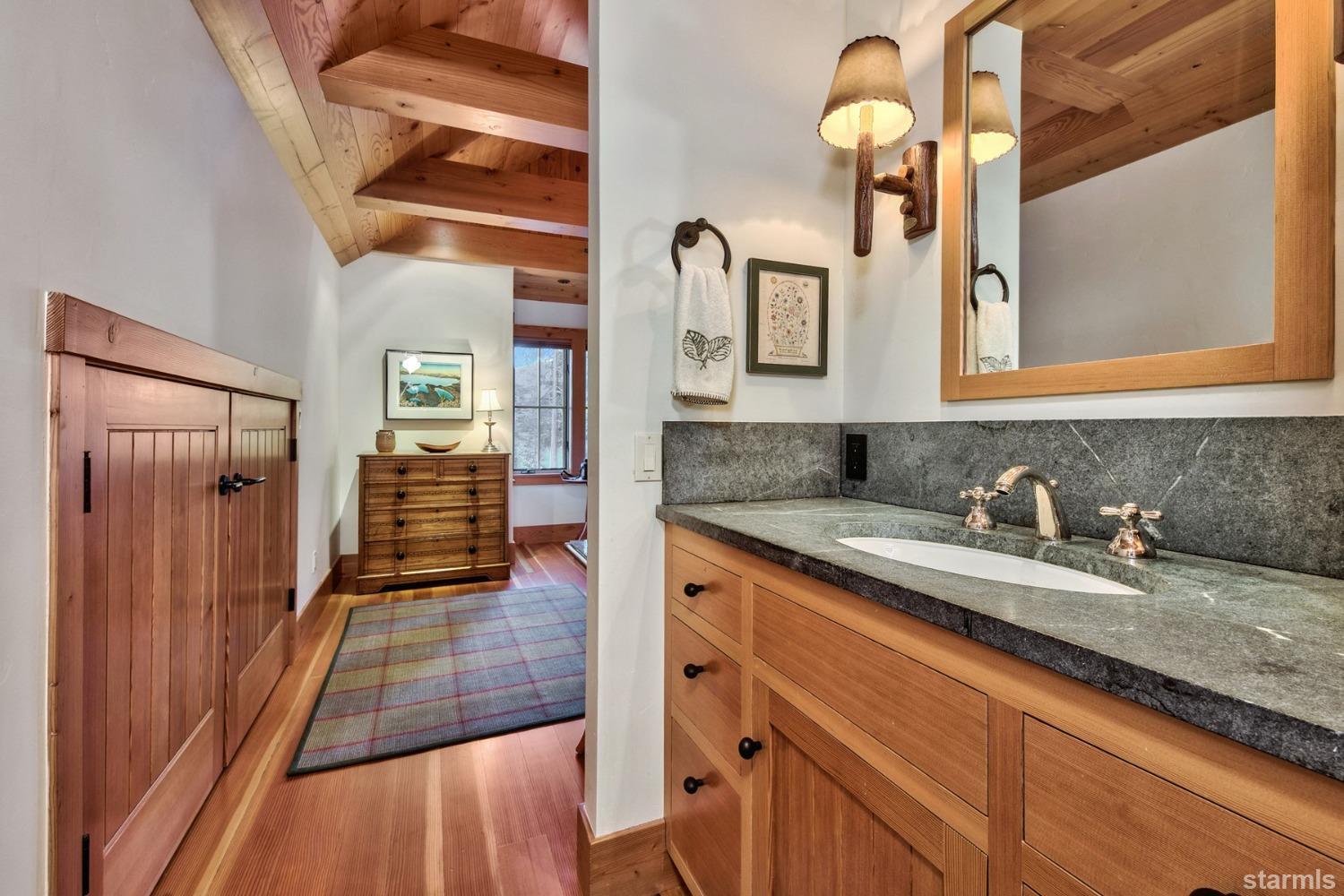 373 Fallen Leaf Road Fallen Leaf, CA 96150 - Photo 13 of 40 a en suite bathroom with a granite countertop sink and a mirror